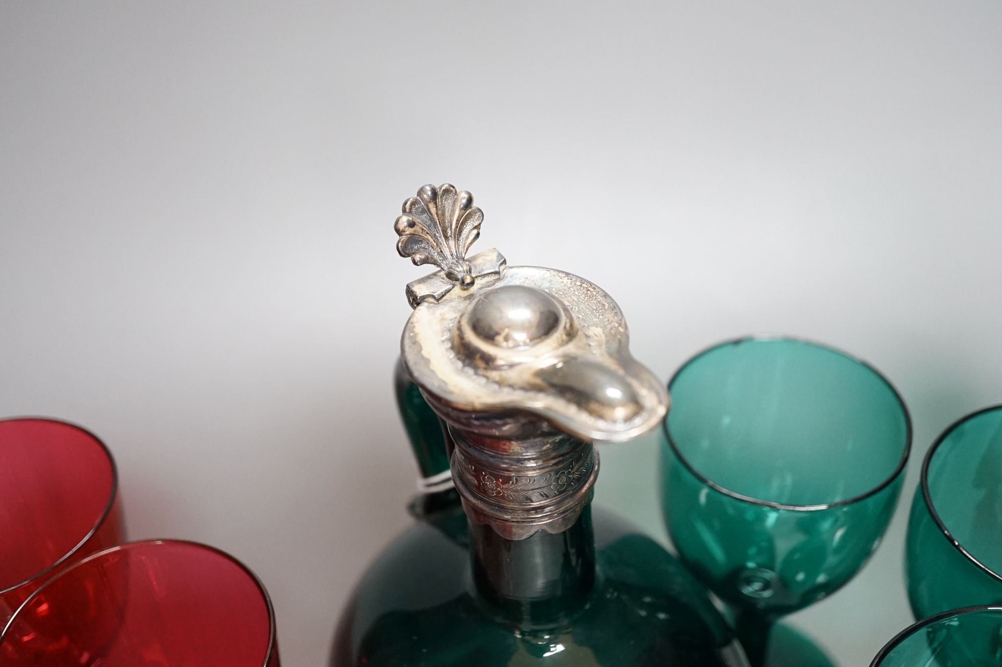 A Victorian dark green glass hock jug, five dark green wine glasses and 6 cranberry bowled wine glasses (12)
